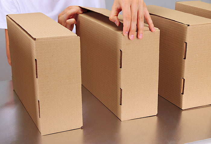 Worker working with boxes at conveyor belt