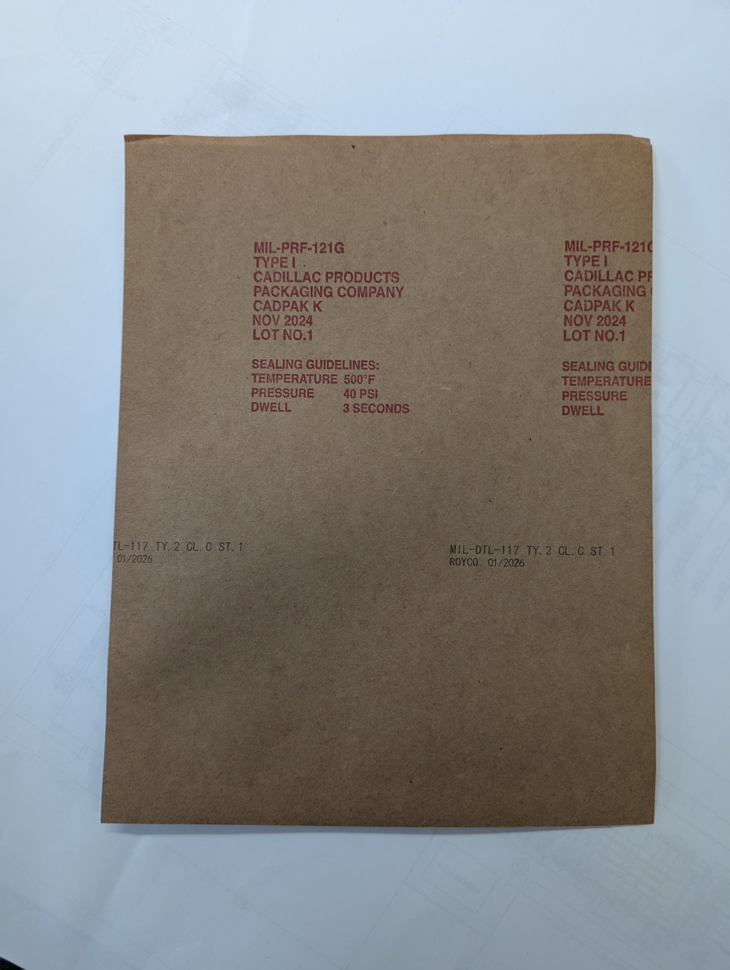 Brown paper bag with printed text on a white background